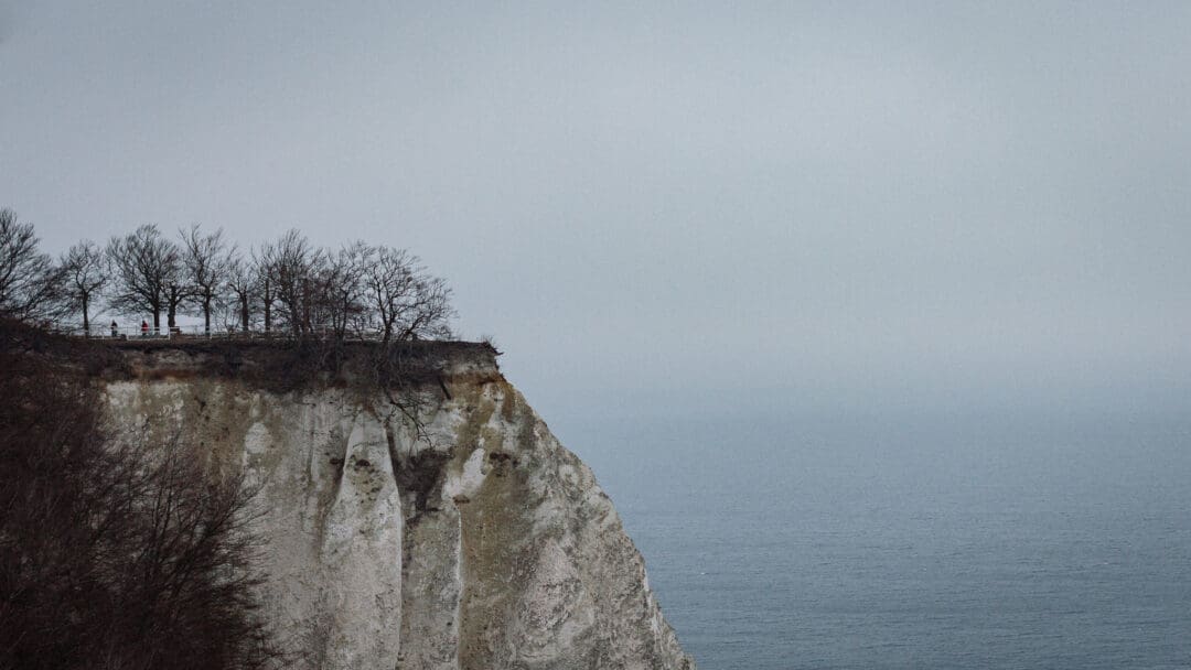 Klippe der weißen Kreidefelsen stehen hoch über der ruhigen, nebeligen Ostsee.